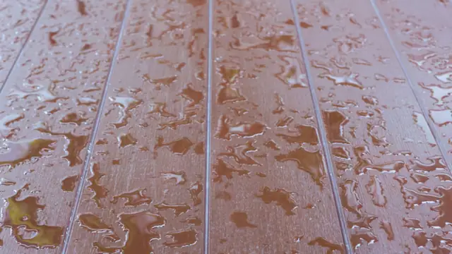 Water beads on a wood plank floor